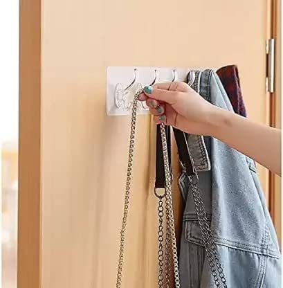 Wall hooks holding kitchen utensils and towels