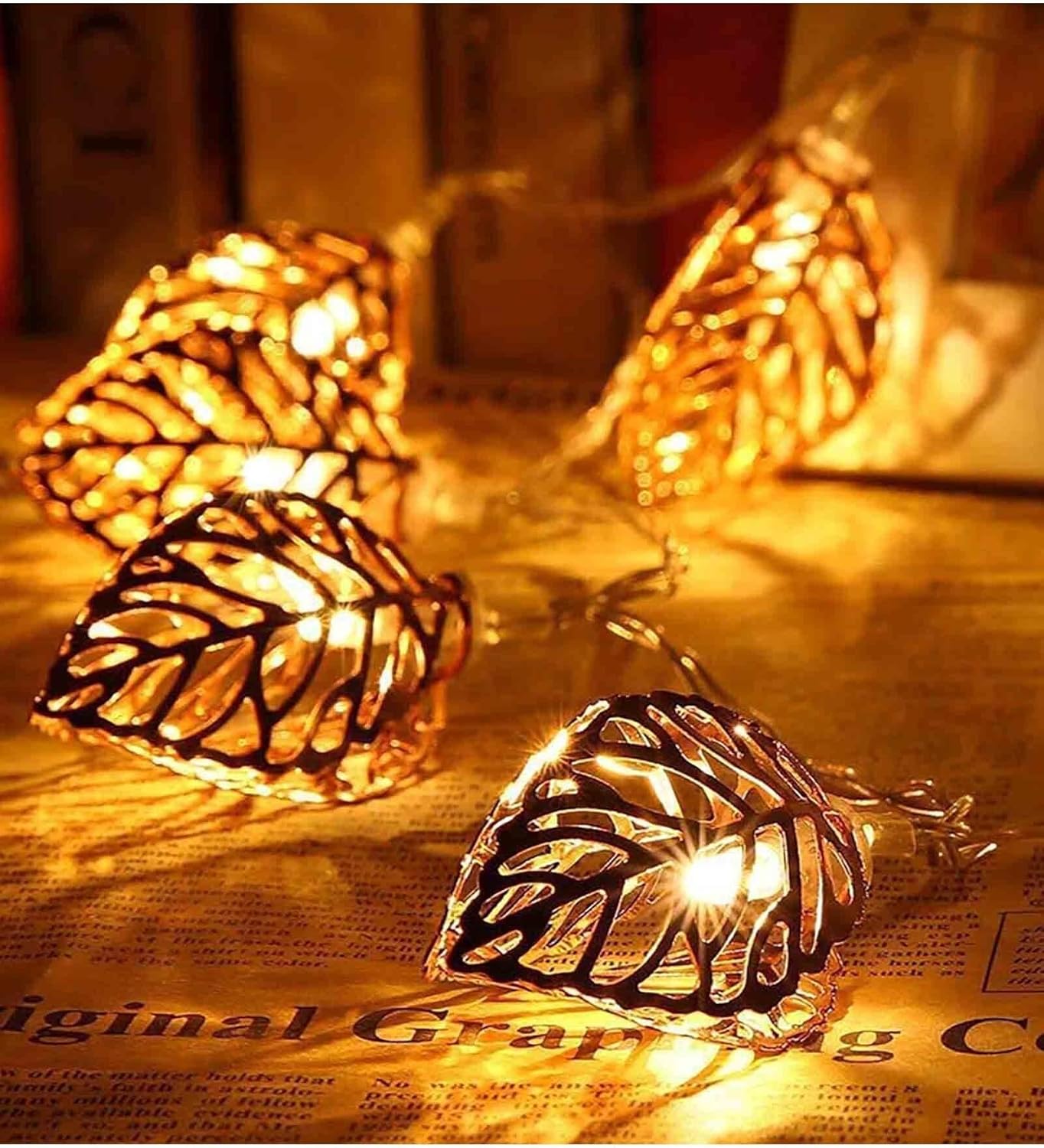 Close-up of the tree leaf-shaped metal LED lamps with golden glow