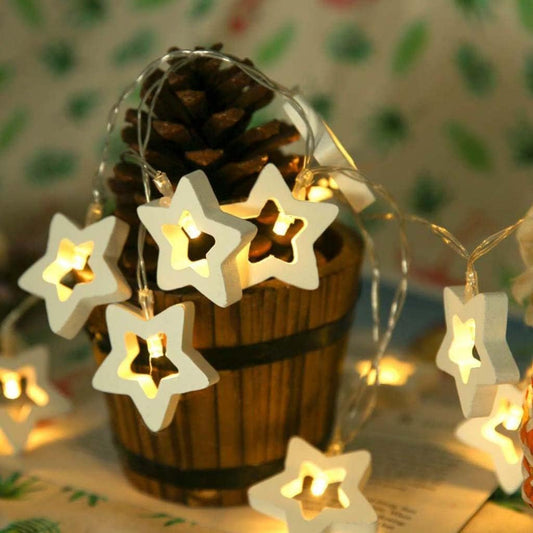 White wooden star LED string lights glowing with warm white light